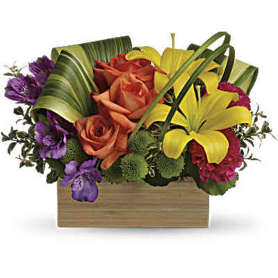 Orange roses and yellow lilies in a wooden box