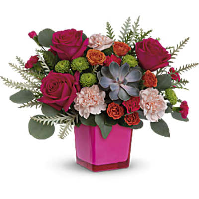 Pink and orange flower arrangement in a magenta vase