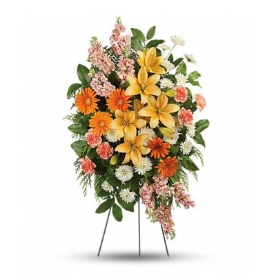 Standing floral spray with yellow lilies, orange daisies, and pink carnations
