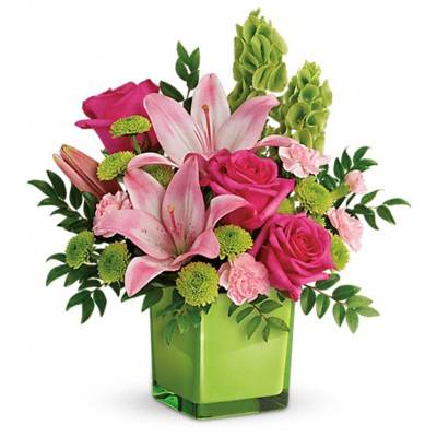 Pink roses and lilies in a green square vase