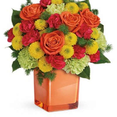 Orange roses and red-yellow mums in a square glass vase