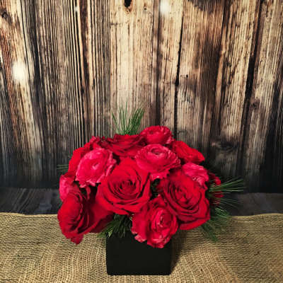 Red rose bouquet in a black square vase