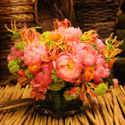Pink and orange floral arrangement in a glass vase