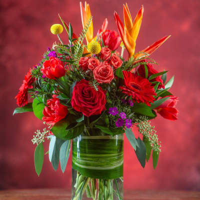 Bouquet of red and orange flowers in a glass vase