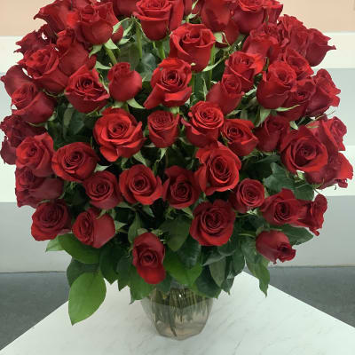 Large bouquet of red roses in a clear glass vase