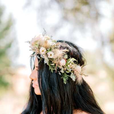 Woman wearing a floral crown with white and blush flowers