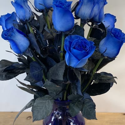 A dozen Blue Roses arranged in blue glass vase- W653