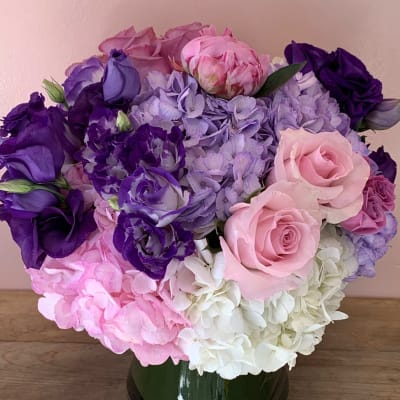 Pink, purple, and white flower bouquet in a glass vase
