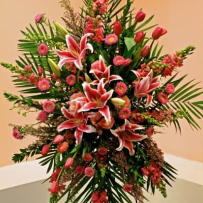 Tall floral standing spray with pink lilies and tulips