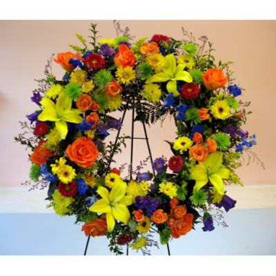 Colorful floral wreath on a stand with roses and lilies