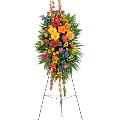 Tall standing floral spray with bright mixed flowers on an easel