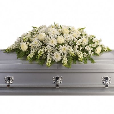 White floral casket spray with green accents