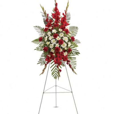 Standing floral spray of red and white flowers on an easel