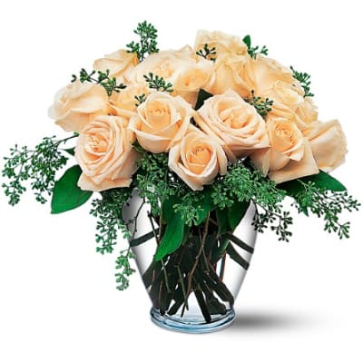 Peach roses arranged in a clear glass vase