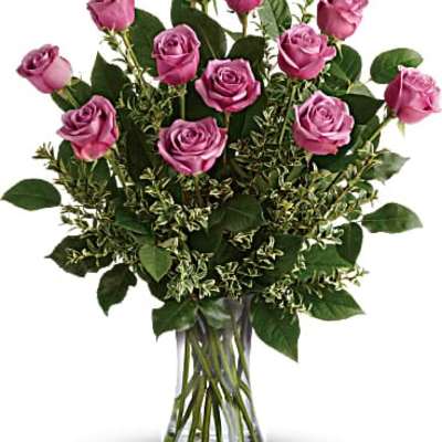 Pink roses arranged in a clear glass vase