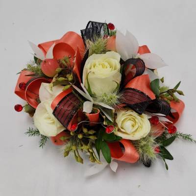 Cream roses with red and black ribbon accents