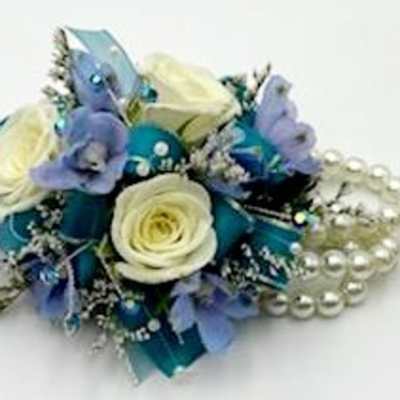 Blue and white floral corsage with pearl accents