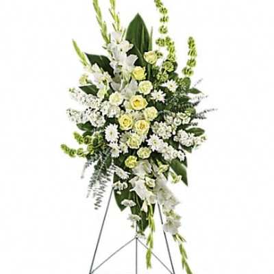 Tall white and pale yellow floral standing spray on an easel