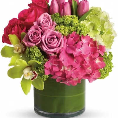 Pink roses and tulips with hydrangea in a glass vase