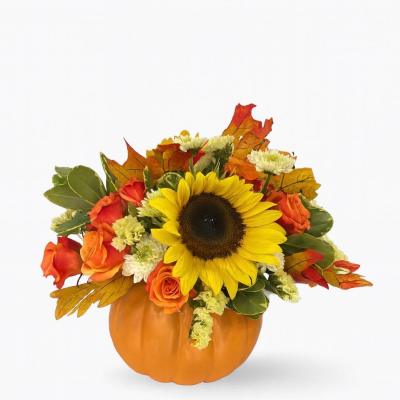 Sunflower and orange rose arrangement in a pumpkin container