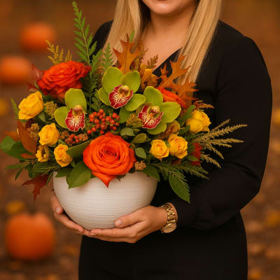 Woman holding a white bowl of orange and yellow flowers