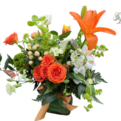 Orange lilies and roses arranged in a vase with white flowers