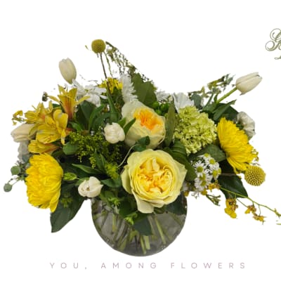 Yellow and white flower arrangement in a glass vase