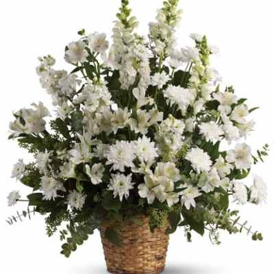 White floral arrangement in a woven basket