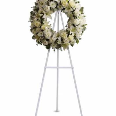 White floral wreath on a standing easel