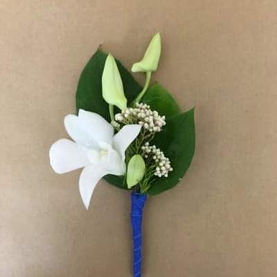 White boutonniere with green buds and leaves on a blue wrapped stem
