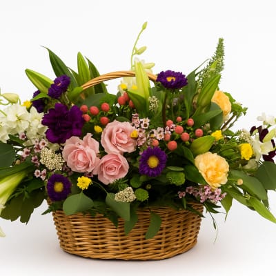Mixed flower basket with pink roses, lilies, and purple blooms