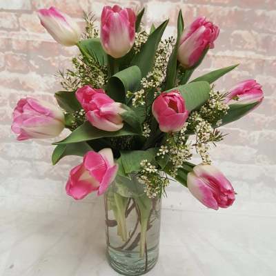 Pink tulips arranged in a clear glass vase