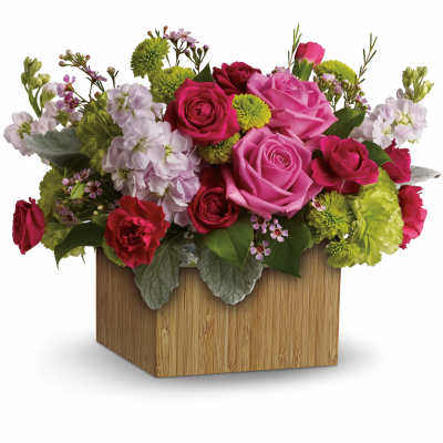 Pink and red rose arrangement in a wooden cube vase