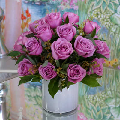 Bouquet of lavender roses in a white vase