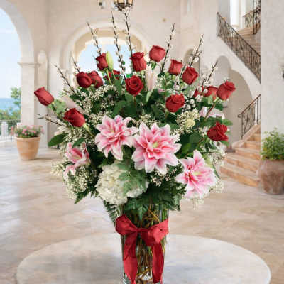 Tall vase arrangement with red roses and pink lilies