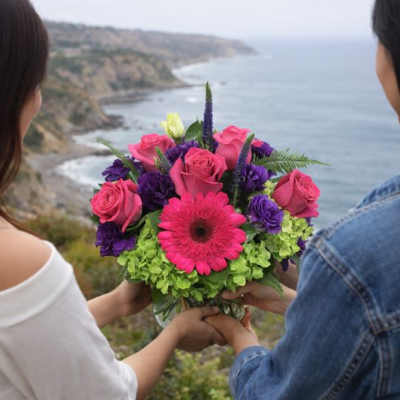 Bouquet of pink roses, purple blooms, and a pink gerbera daisy