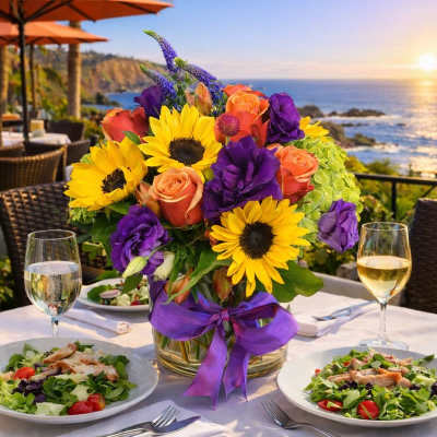 Bright mixed bouquet with sunflowers and roses in a glass vase on a table