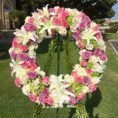 Large floral wreath of pink and white roses with white lilies