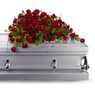 Red rose casket spray on a silver casket