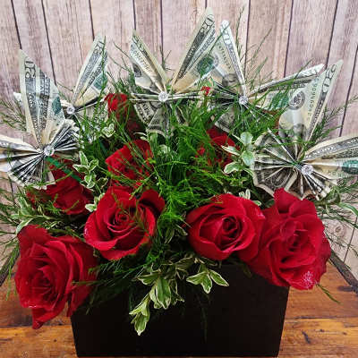 Red roses with dollar-bill paper flowers in a black box