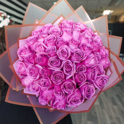 Bouquet of pink roses wrapped in translucent paper