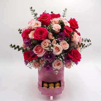 Pink and red rose arrangement in a velvet box with chocolates