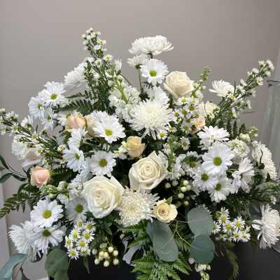 White daisies and cream roses arranged in a large bouquet