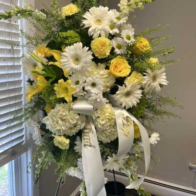 Tall white and yellow floral standing spray with ribbon