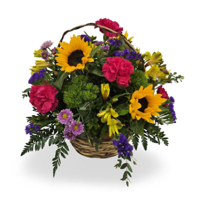 Basket arrangement with sunflowers, pink carnations, and purple flowers