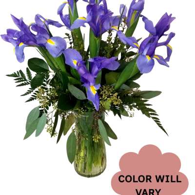 Purple iris bouquet in a clear glass vase