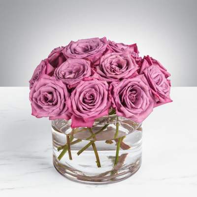 Pink roses arranged in a clear glass vase