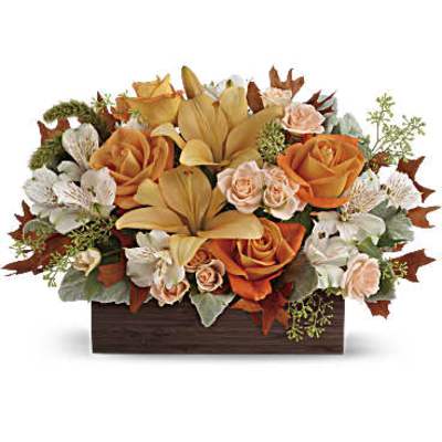 Orange roses and lilies in a rectangular wooden container