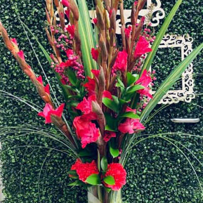 Tall pink floral arrangement in a clear glass vase