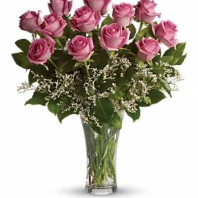Pink roses arranged in a clear glass vase